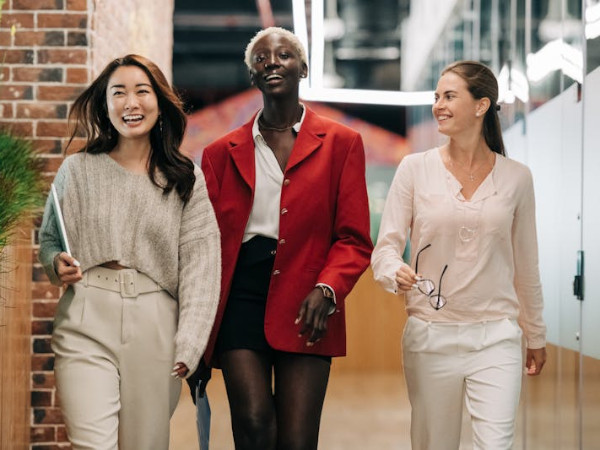 three women in business walking down the hallway