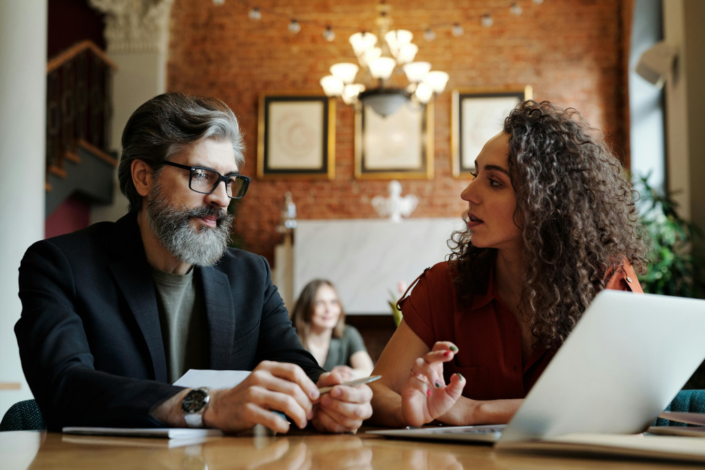 Photo by Edmond Dantès: https://www.pexels.com/photo/a-man-in-black-suit-sitting-beside-the-woman-in-brown-shirt-4339865/