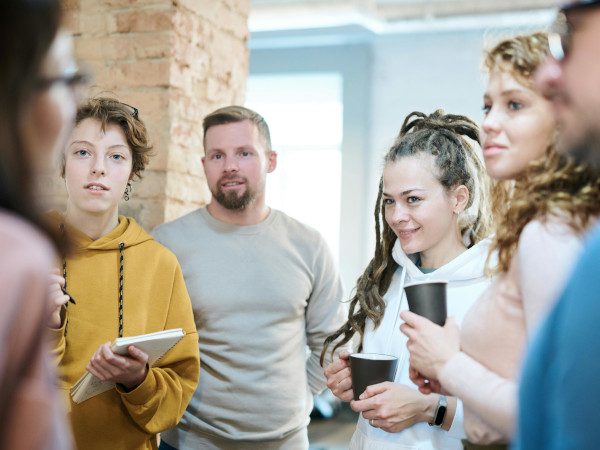 team members listening to lady with glasses