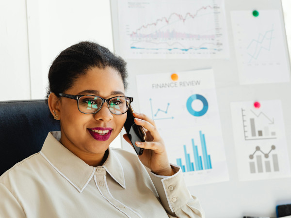 Woman Wearing Black Framed Eyeglasses Holding her Smartphone on her Ear