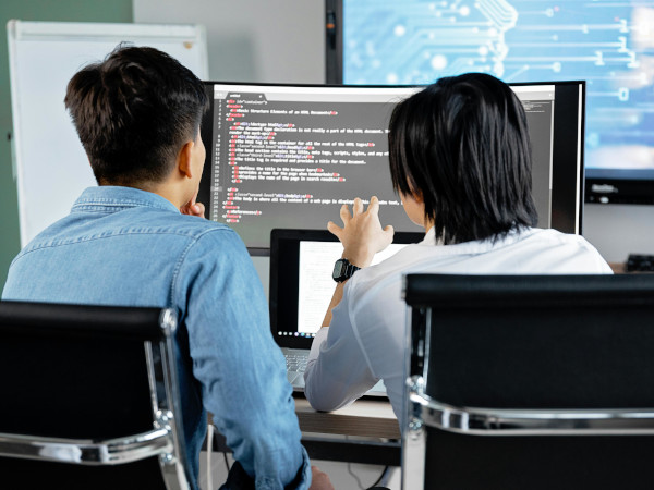 two men starting at the computer